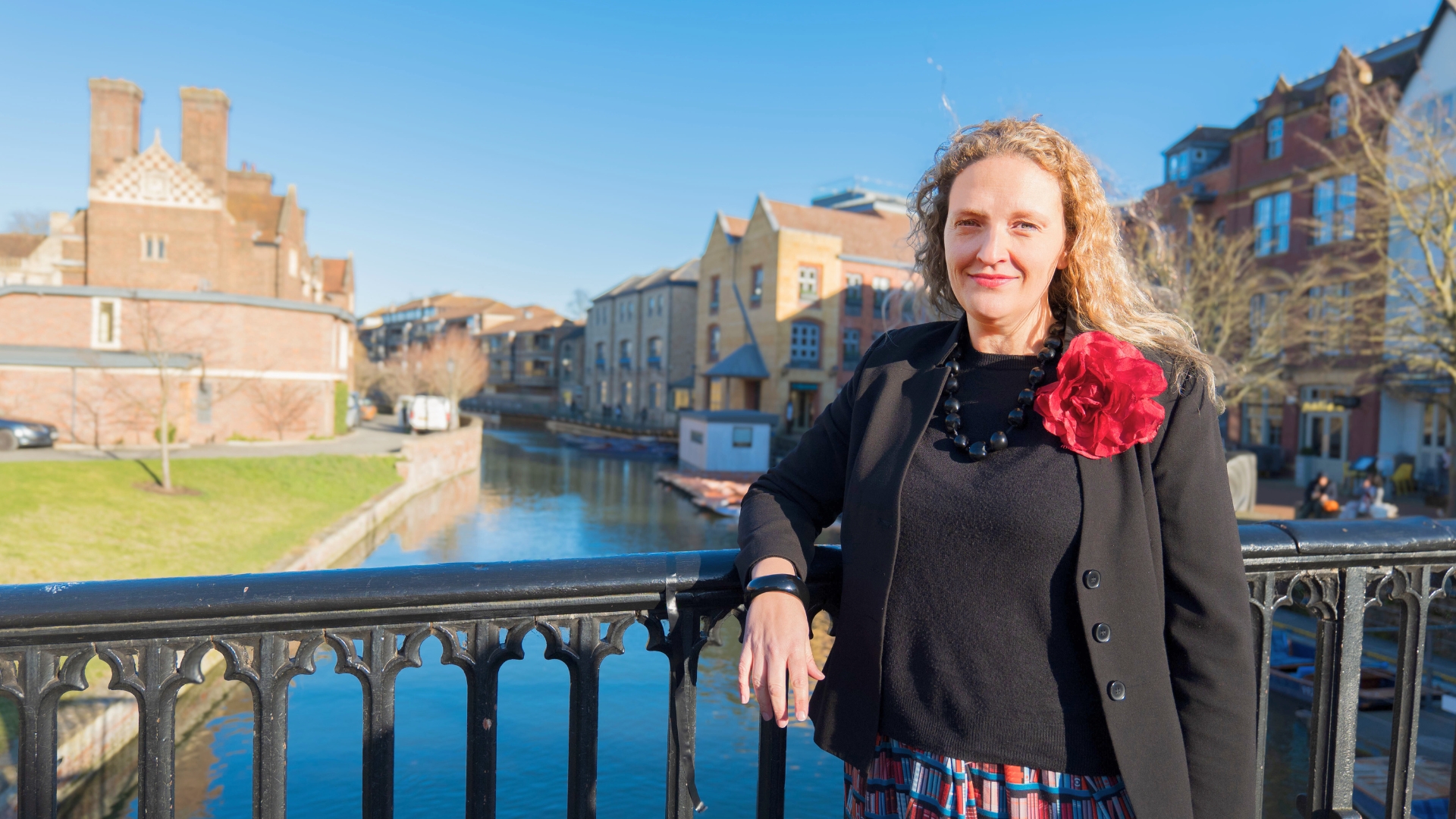 Alice Macek standing on a bridge over the river Cam
