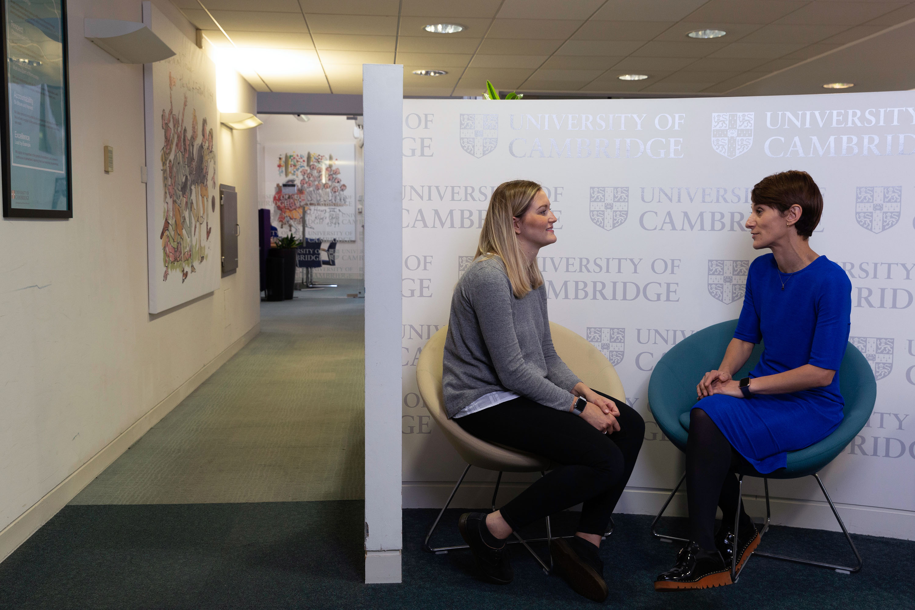Two people having a conversation in an office