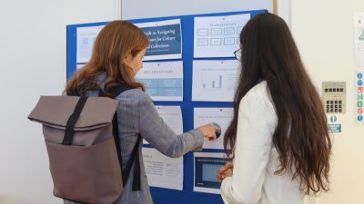 Interns looking at a poster board together