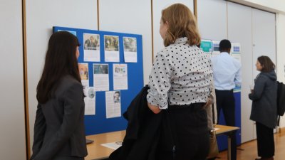 Interns looking at a poster board together