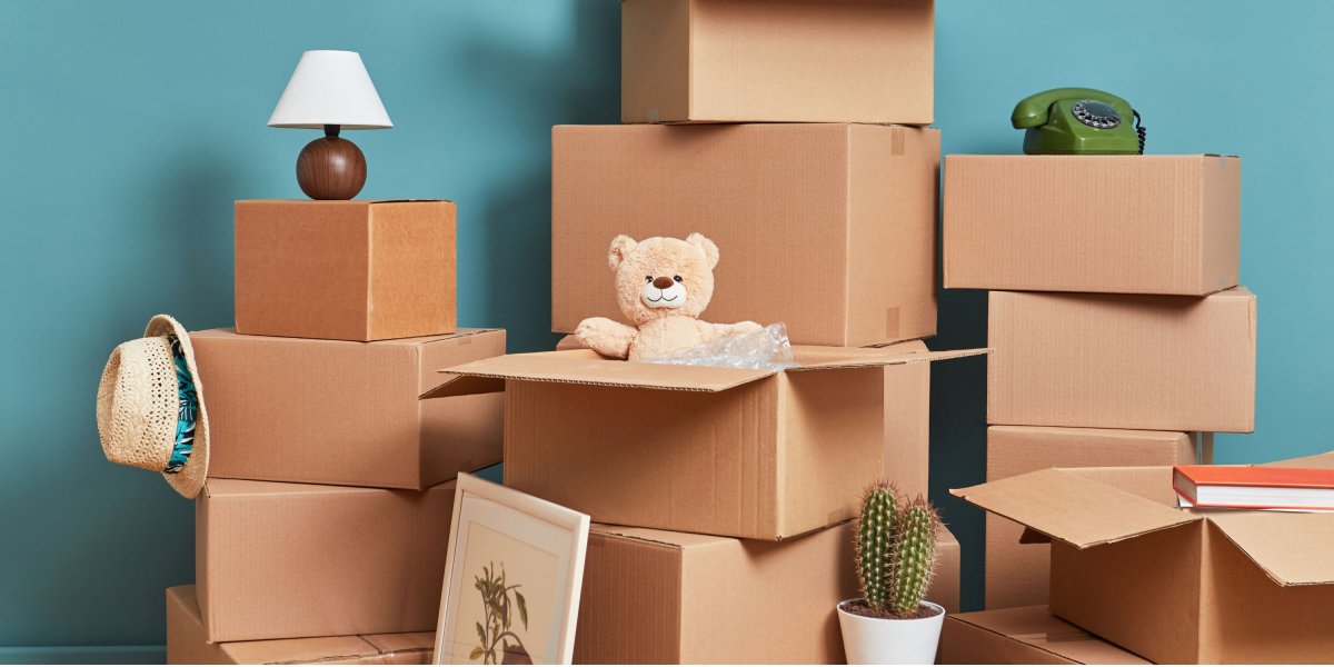 Piles of boxes with household goods and books packed into them.