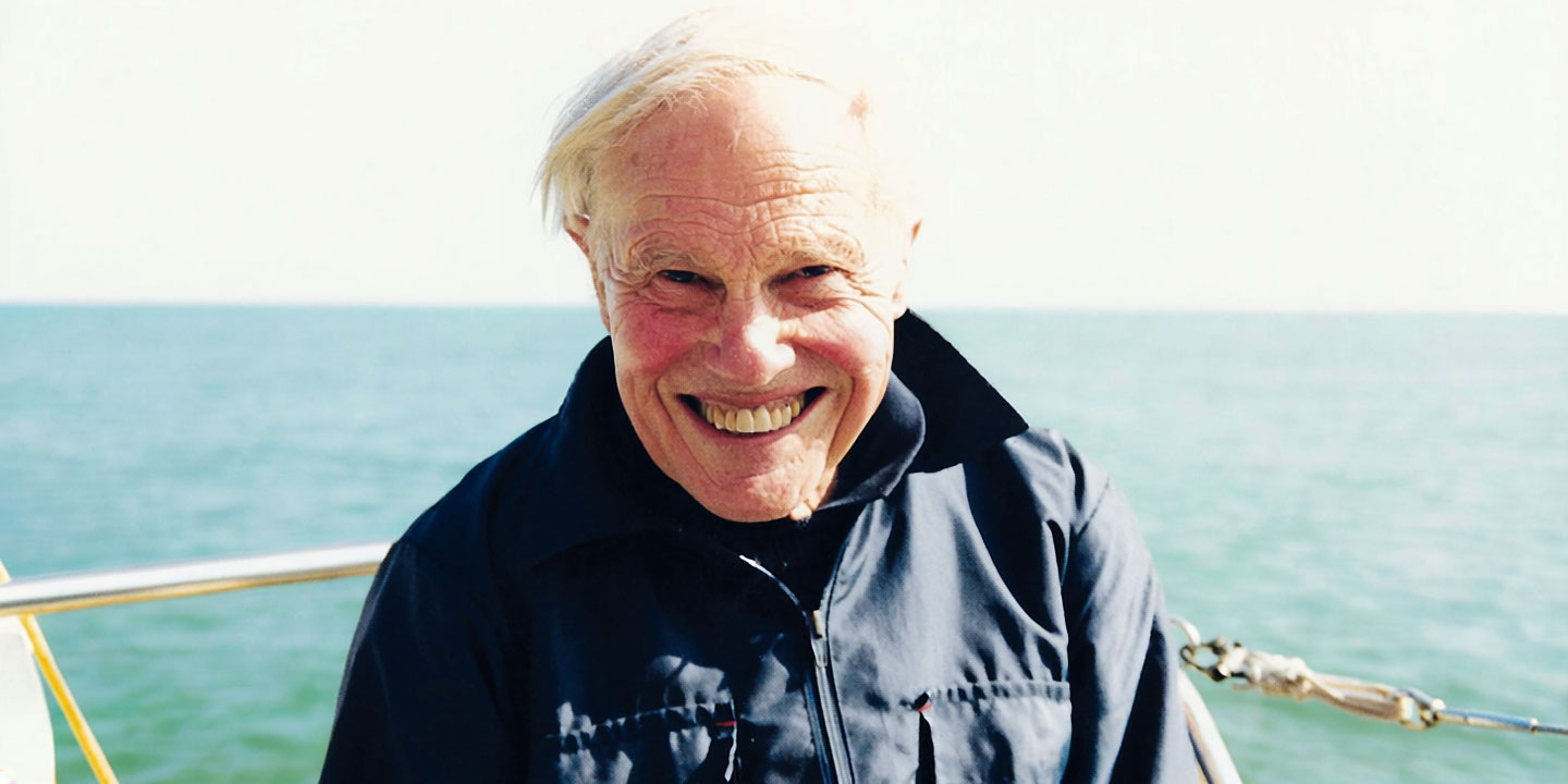 Robert Perrin smiling at the camera with the ocean behind him
