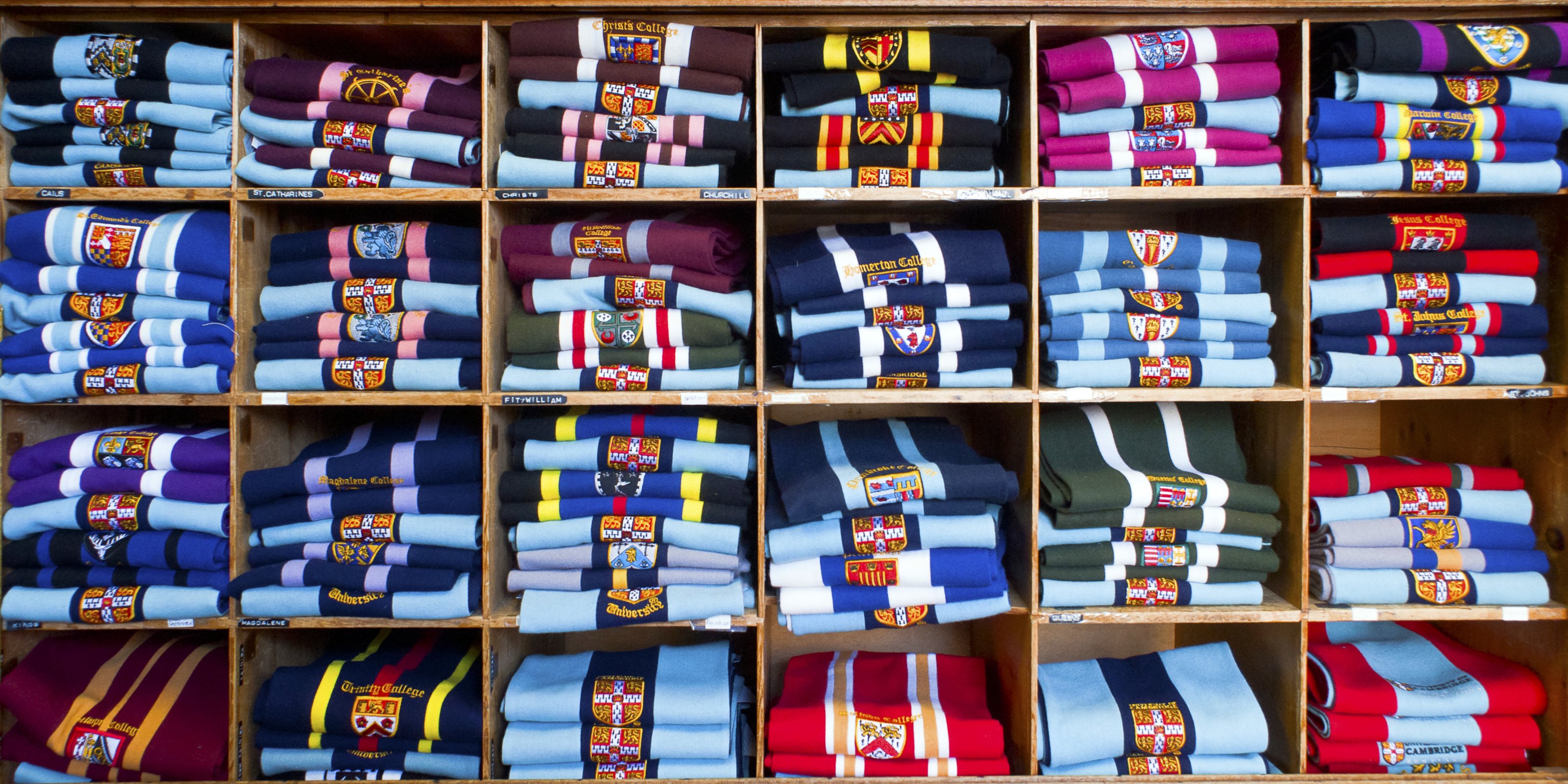 College scarves stacked on shelves