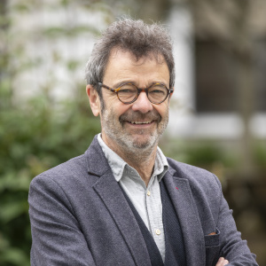 Photograph of Professor Manuel Eisner, wearing a grey suit jacket.
