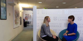 Two people having a conversation in an office