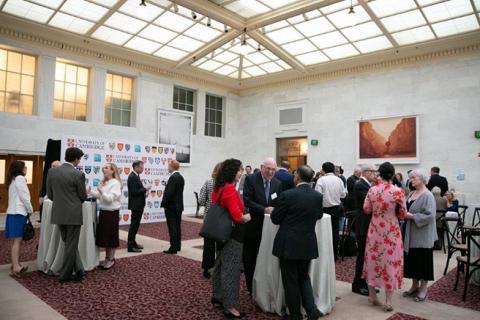 Lots of people gathered in a hall having discussions