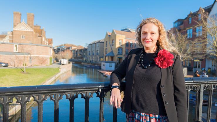 Alice Macek standing on a bridge over the river Cam