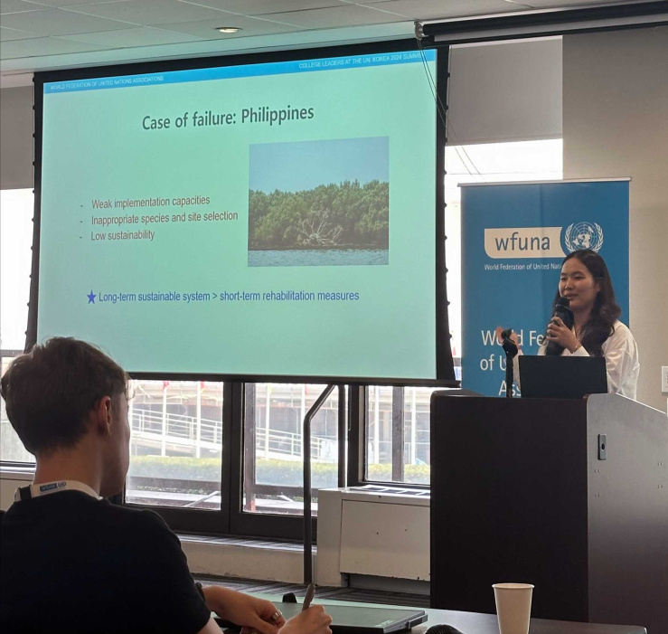 Victoria presents on her topic at a conference