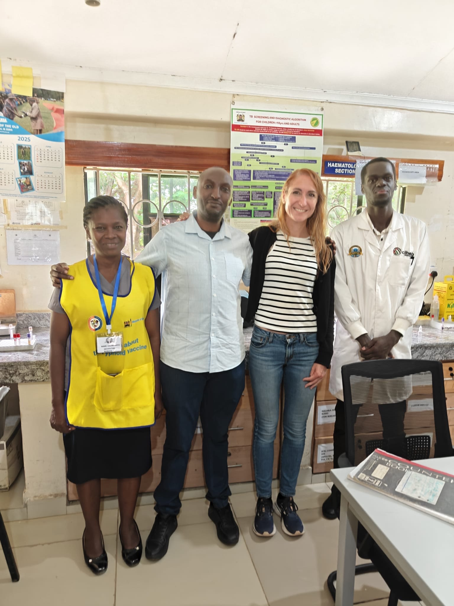 Photograph showing four people stood in a healthcare setting