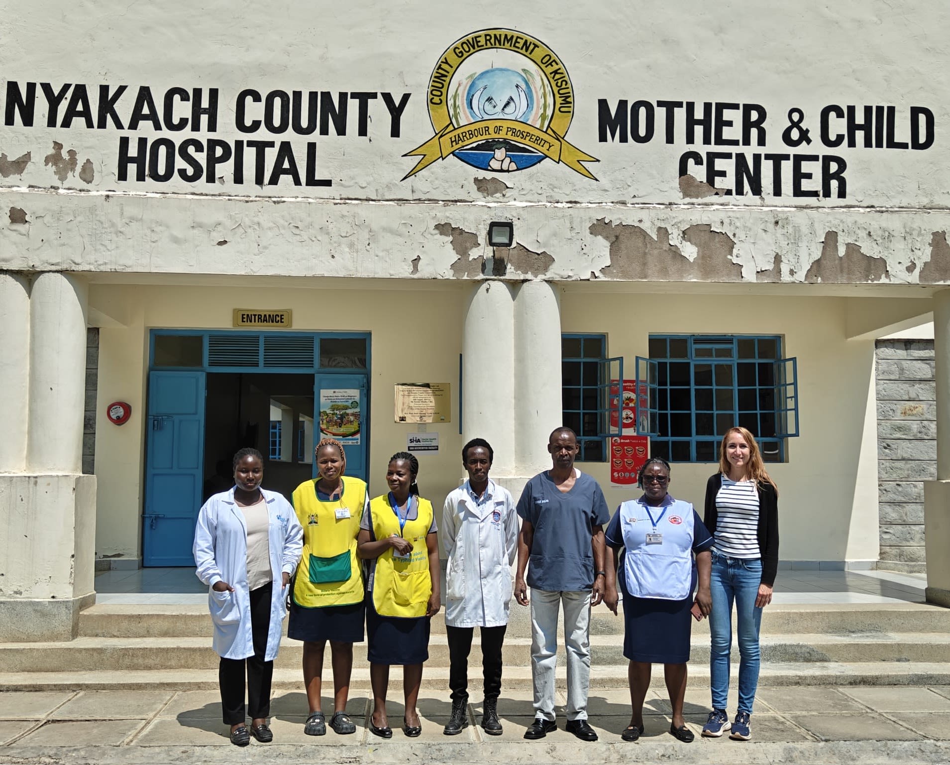 healthcare professionals stood outside a local Kenyan maternity healthcare unit