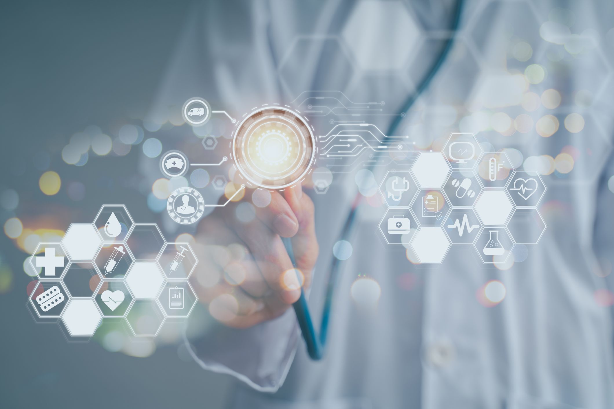 image of a healthcare professional pointing at a set of holographic health related icons and symbols