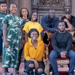 Stormzy seated and surrounded by students from the University of Cambridge Afro-Caribbean Society