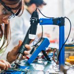 Two people working on circuit boards in an office