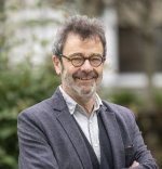 Photograph of Professor Manuel Eisner, wearing a grey suit jacket.