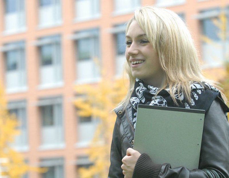 A student in front of the Faculty of English