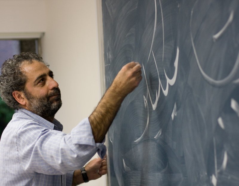 Writing Arabic on a board during a talk