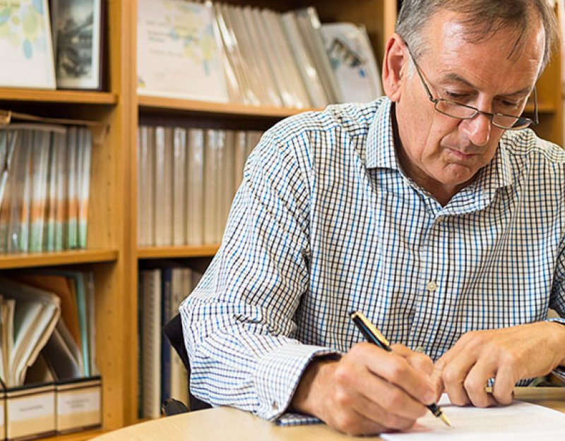 A professor at work in his study