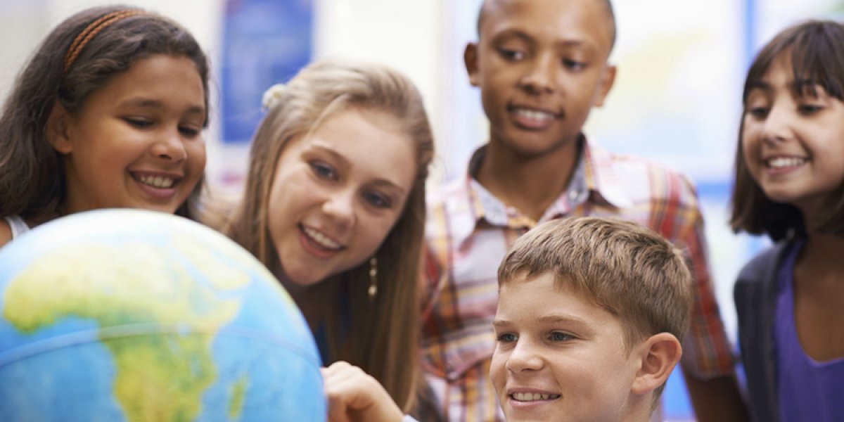 Children looking at globe 
