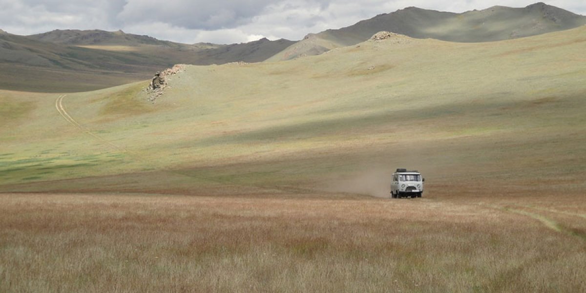 A van makes its way through a grassland landscape. Image courtesy of Professor Ulf Büntgen