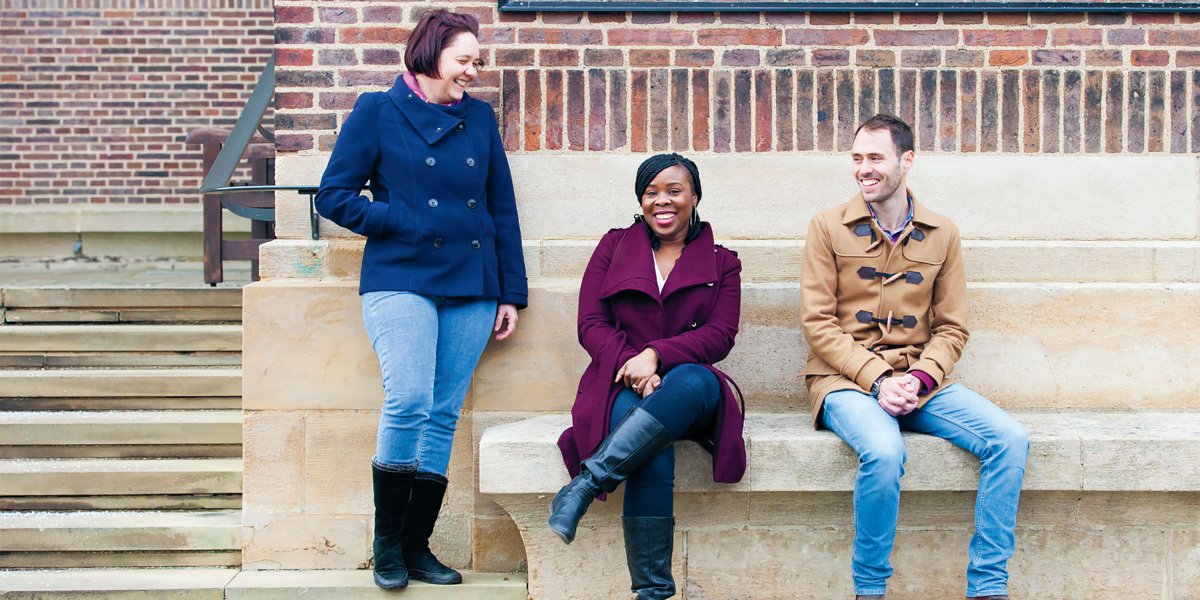 Casey Millward, Carol Ibe and Francis Heil standing outside the brick wall of the University Librar UL