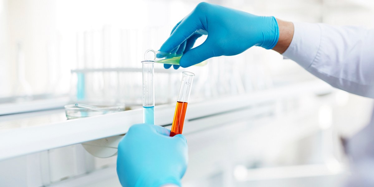 Pouring a chemical into a test tube