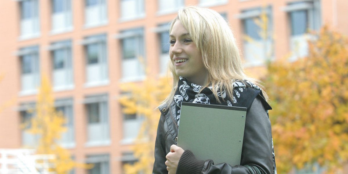 A student in front of the Faculty of English