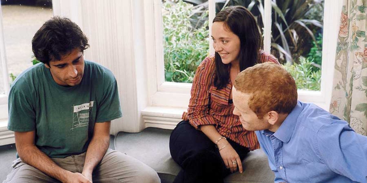 Students sitting in a window seat discussing work. Photo credit: Nigel Luckhurst. Copyroght: University of Cambridge