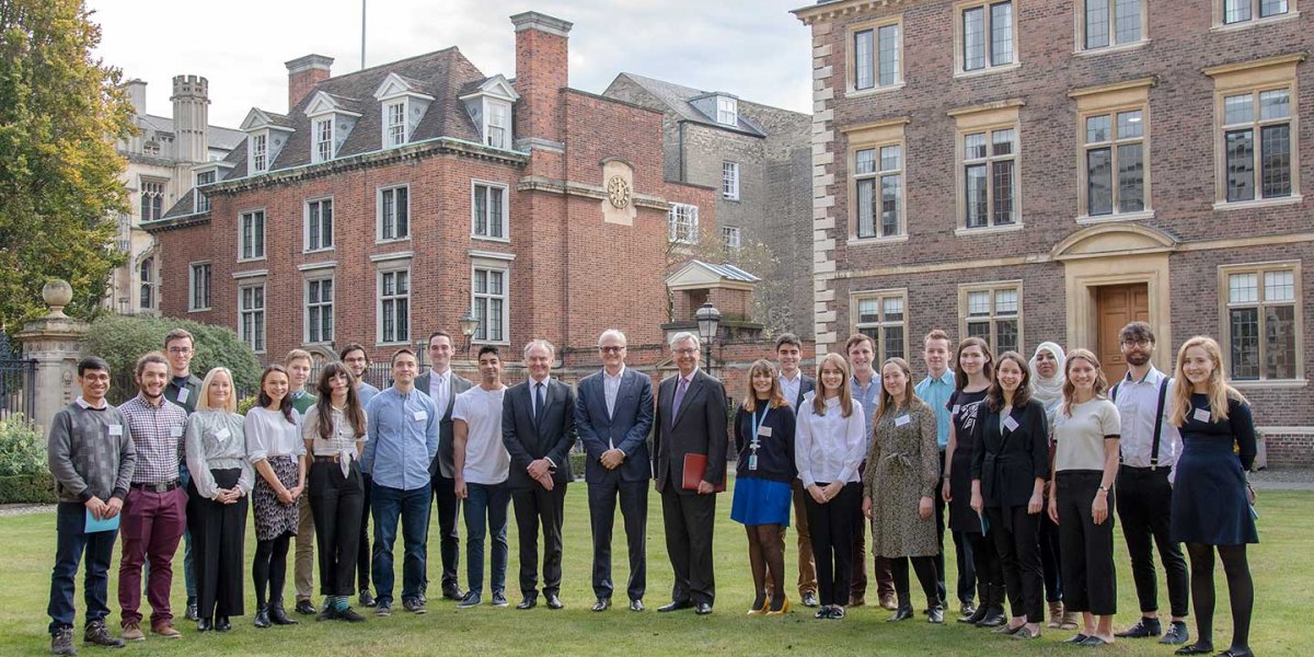 23 Harding Scholars standing in front of St Catherine's College with the VC Stephen Troope and philanthropist David Harding