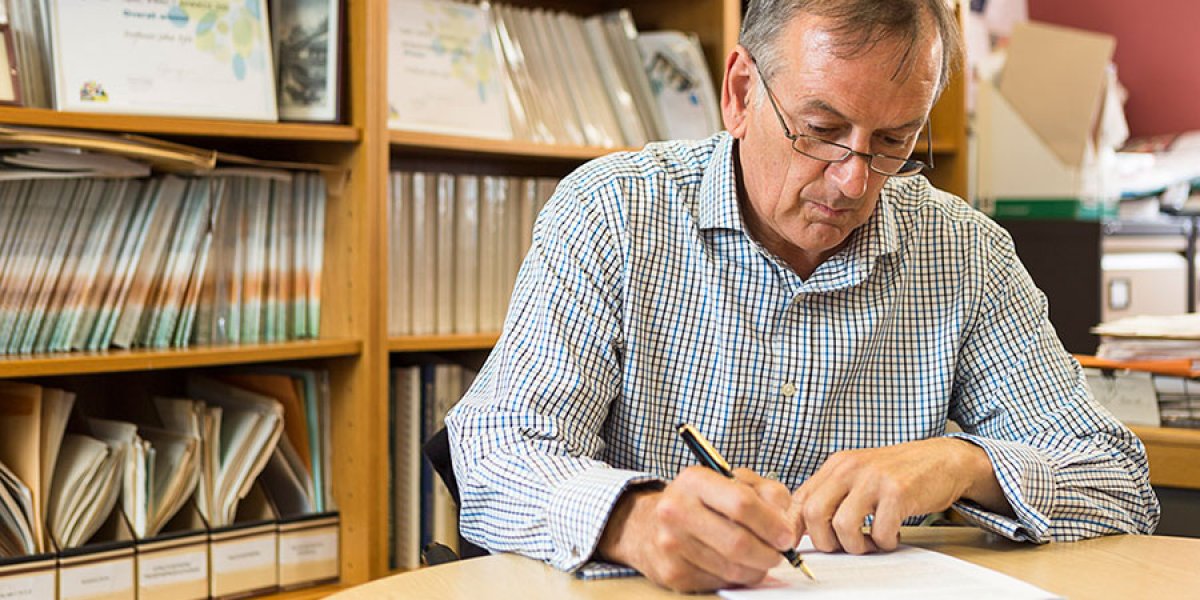 A professor at work in his study