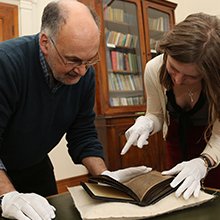 Paul Russell, Professor of Celtic, examining a text with a colleague